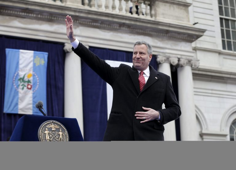 New York City Mayor Bill de Blasio waves after being sworn in during the public inauguration ceremony at City Hall in New York City, on Jan. 1. (AP Photo/Seth Wenig)