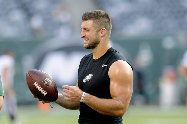 Former Philadelphia Eagles quarterback Tim Tebow handles a football before a preseason NFL football game against the New York Jets Thursday, Sept. 3, 2015 in East Rutherford, N.J. (AP Photo/Bill Kostroun)