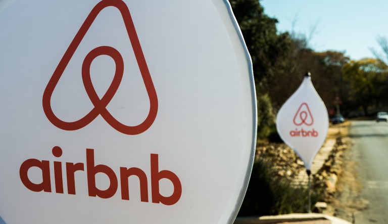 The logos of Airbnb Inc. sit on banners displayed outside a media event in Johannesburg, South Africa, on Monday, July 27, 2015.