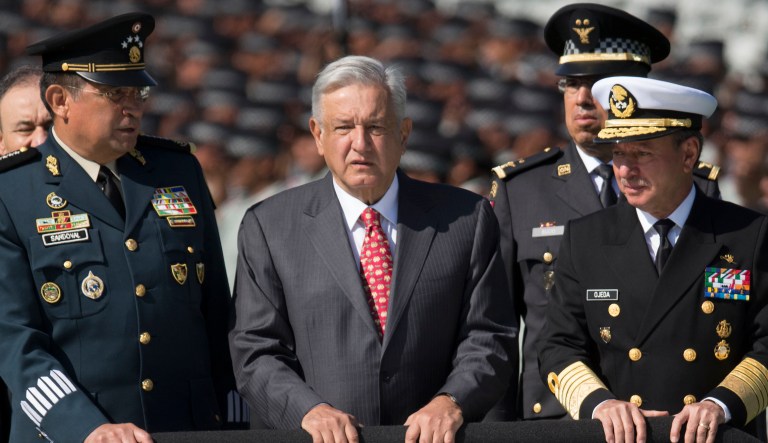 Mexican President Andres Manuel Lopez Obrador, between Defense Secretary Gen. Luis Crescencio Sandoval, left, and Marine Secretary Jose Rafael Ojeda.