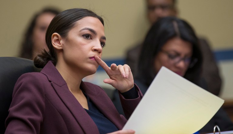 Rep. Alexandria Ocasio-Cortez, D-N.Y., listens to questions as Michael Cohen, President Donald Trump's former personal lawyer, testifies before the House Oversight and Reform Committee, on Capitol Hill, Wednesday, Feb. 27, 2019, in Washington.