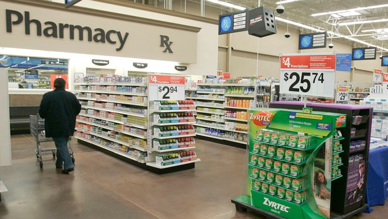 A shopper walks toward the pharmacy at a Little Rock, Ark., Wal-Mart store.