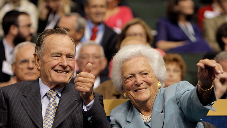 Former President George H.W. Bush and his wife, Barbara, wave to friends in the crowd during the Republican National Convention.