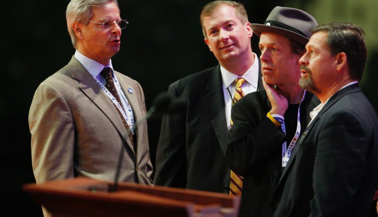 Brett O'Donnell (second from left) stands with advisers to Sen John McCain on the podium ahead of a 2008 presidential campaign speech  (AP Photo/Charles Dharapak) 