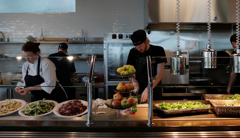 Workers prepare food in the employee cafeteria of Google's campus in Kirkland, Wash., on Oct. 28, 2009. Employees can eat free at several different kitchen facilities on Google campuses.