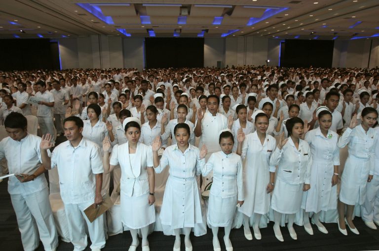 New Filipino professional nurses take their oaths during a ceremony at a Manila convention center Monday, Sept. 20, 2010, in the Philippines. More than 37,000 nurses passed the July 2010 Nursing Board examinations from the 91,000 who took the exams around the country. 