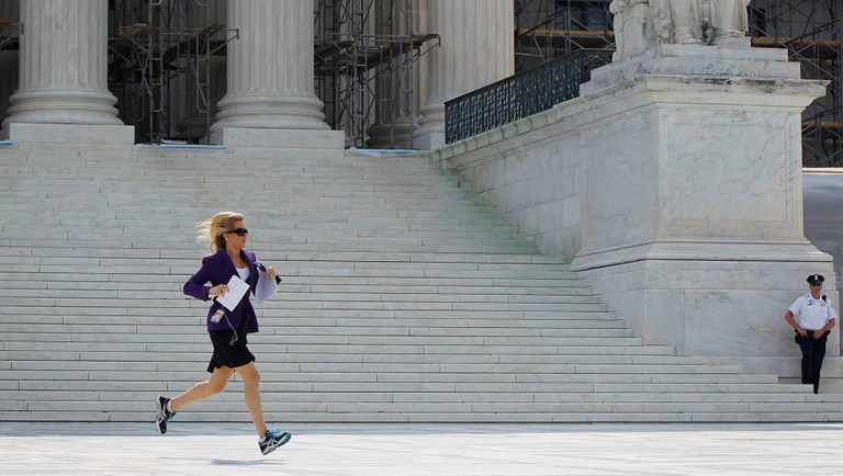 Fox News Channel reporter Shannon Bream is seen sprinting across the steps of the Supreme Court after the released of the court's decision on Arizona's controversial immigration law known as SB 1070, Monday, June 25, 2012 in Washington.