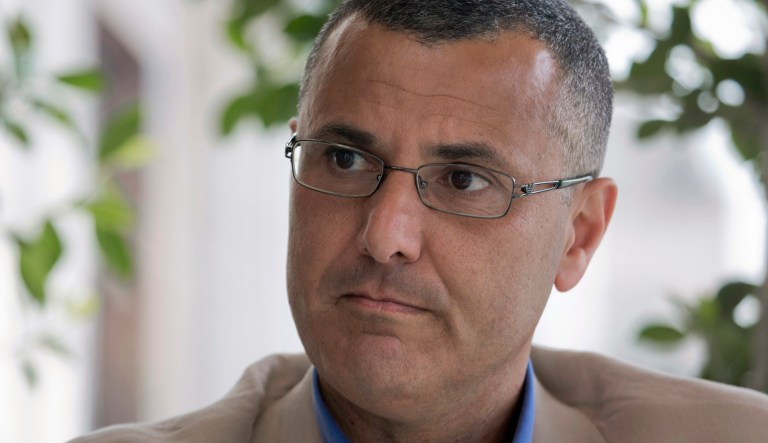 Omar Barghouti listens during an interview with the Associated Press in the West Bank city of Ramallah, Tuesday, May 10, 2016. Barghouti, a Qatari-born Palestinian who is married to an Israeli woman and leader of the international boycott movement against Israel, on Tuesday accused Israeli authorities of imposing a travel ban on him as retribution for his political activities.