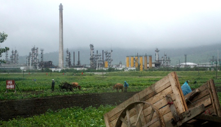 Farmers work their fields outside the Sungri Chemical Factory, an oil refinery in the Rason Special Economic Zone near North Korea's Russian and Chinese borders that dates back to 1973 but has been idle in recent years.