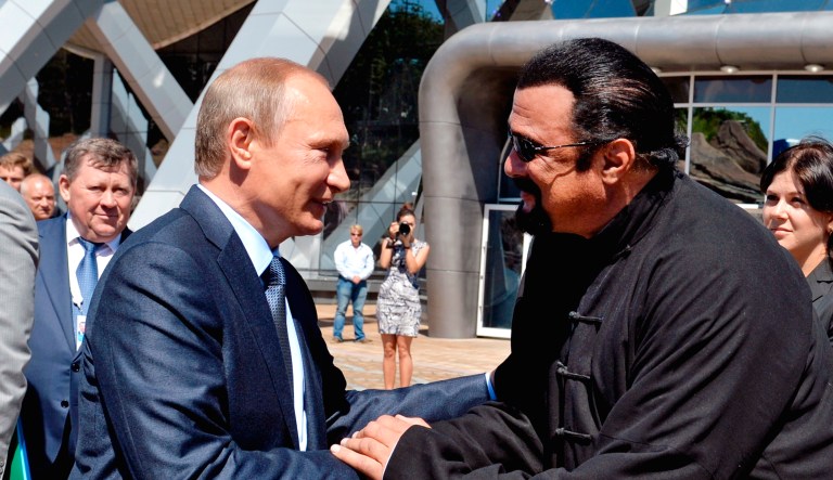 Russian President Vladimir Putin, left, and U.S. actor Steven Seagal shake hands in Vladivostok.