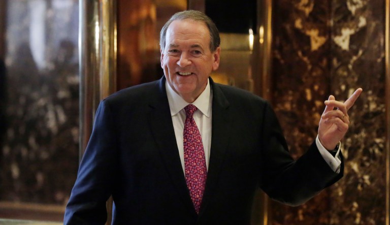 Former Arkansas Gov. Mike Huckabee waits for the elevator at Trump Tower in New York. 
