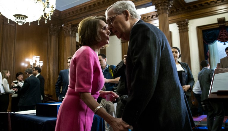 House Minority Leader Nancy Pelosi of California speaks with Senate Majority Leader Mitch McConnell of Kentucky on Capitol Hill in Washington, Thursday, Dec. 8, 2016, following a signing ceremony for the bipartisan extensive medical funding 21st Century Cures Act.