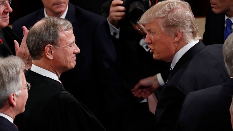 President Trump greets Chief Justice John Roberts on Capitol Hill.