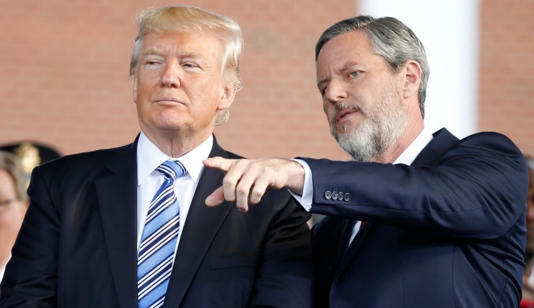 President Donald Trump stands with Liberty University president, Jerry Falwell Jr., right, during commencement ceremonies at the school in Lynchburg, Va., Saturday, May 13, 2017.