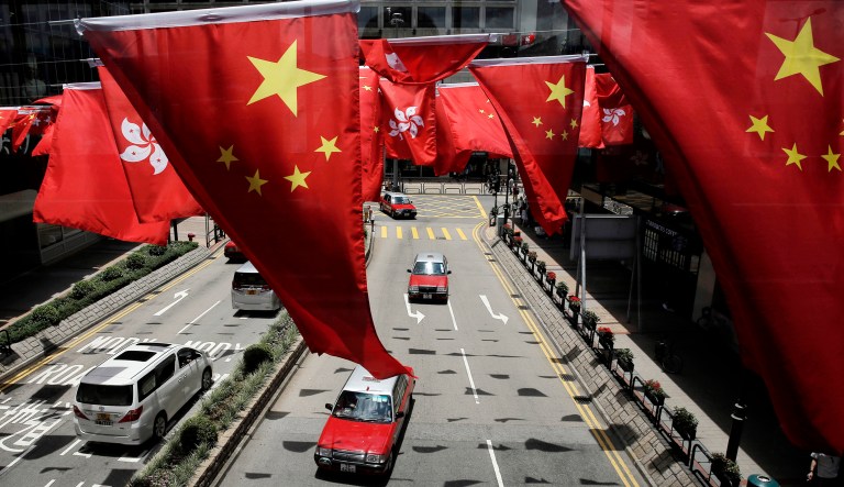China and Kong Hong national flags are displayed outside a shopping center in Hong Kong.