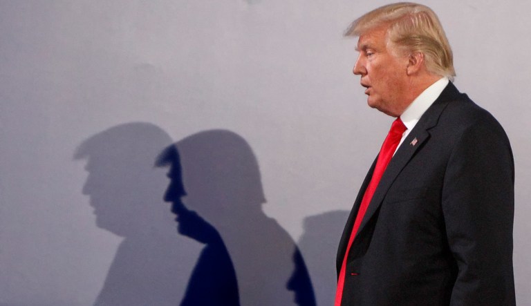U.S. President Donald Trump casts shadows on the wall as he walks with Poland's President Andrzej Duda at the end of a joint press conference, in Warsaw, Poland, Thursday, July 6, 2017.