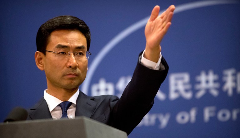 Chinese Foreign Ministry spokesman Geng Shuang gestures to a reporter during a daily press conference at the Ministry of Foreign Affairs in Beijing, July 14, 2017.