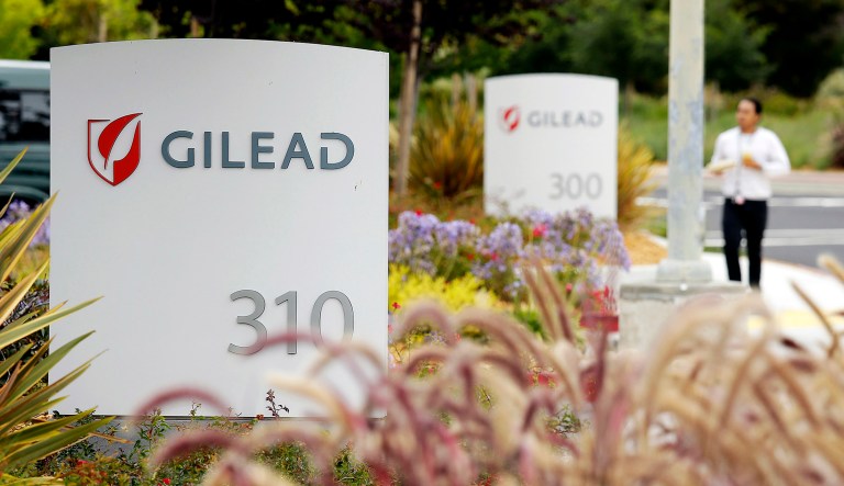 A man walks outside the headquarters of Gilead Sciences in Foster City, Calif.