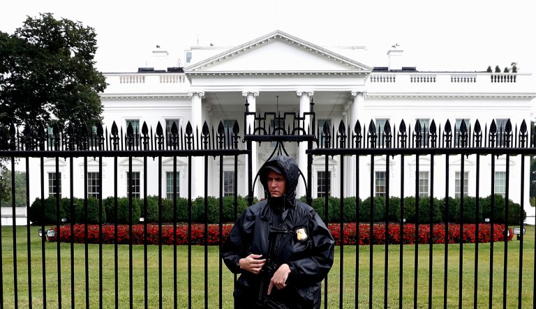 A U.S. Secret Service officer stands guard in the rain in front of the White House in Washington, Friday, July 28, 2017.