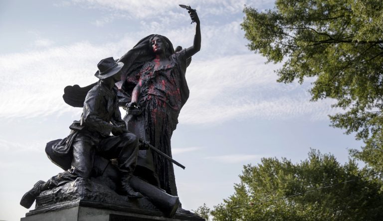 A statue depicting a Confederate soldier in Piedmont Park in Atlanta is vandalized with spray paint Monday, Aug. 14, 2017.