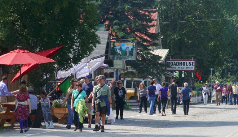 Tourists walk along the businesses of historic Main Street in Talkeetna, Alaska.