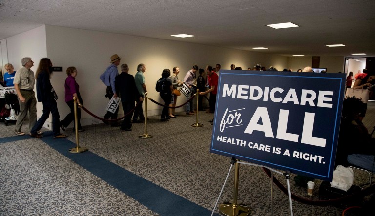 Supporters line up to get into a news conference to unveil their Medicare for All legislation to reform healthcare. 