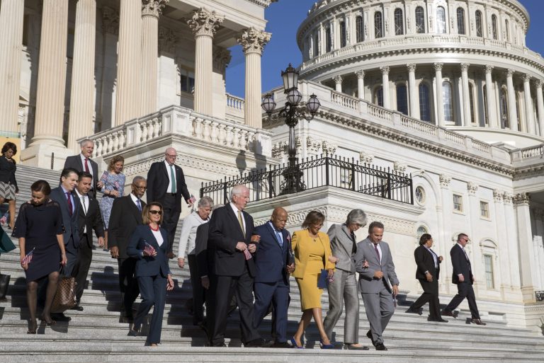 House Minority Leader Nancy Pelosi of California and other Democrats walk down the steps of Capitol Hill in Washington, D.C.