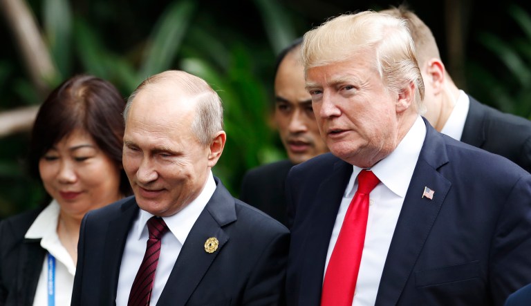 U.S. President Donald Trump, right, and Russia's President Vladimir Putin, center, talk during the family photo session at the APEC Summit in Danang, Vietnam, on Nov. 11, 2017.