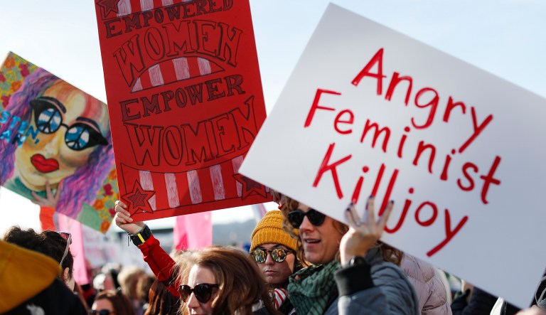 Protesters gather to participate in the Women's March highlighting demands for equal rights and equality for women, Jan. 20, 2018, in Cincinnati.