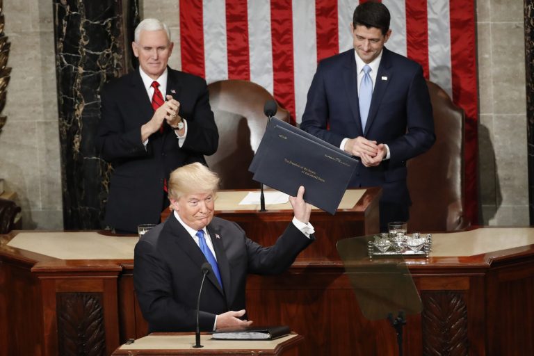 President Trump holds up copies of his speech before the State of the Union address to a joint session of Congress on Capitol Hill in Washington, Tuesday, Jan. 30, 2018. 