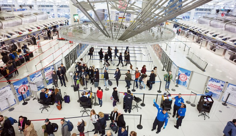 Passengers stand in line as they wait to pass through a TSA security checkpoint at JFK International Airport Friday, March 2, 2018, in New York.