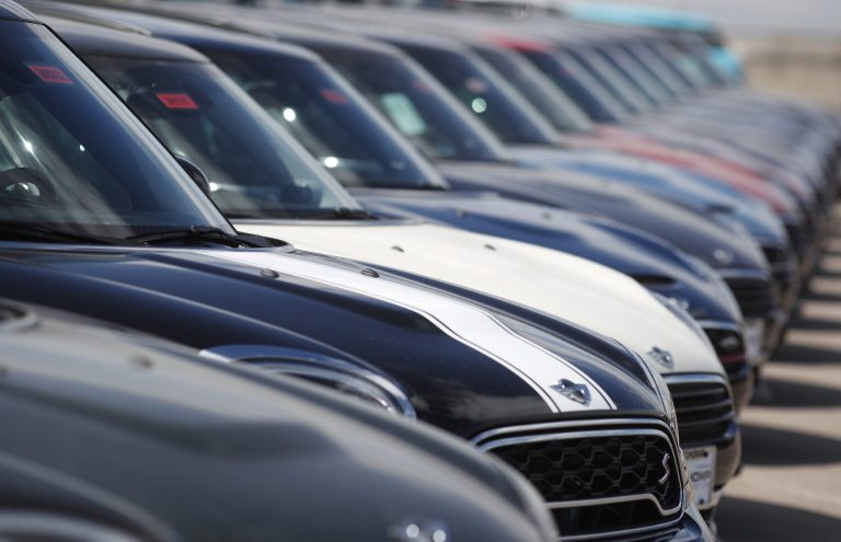 In this Monday, March 12, 2018, photograph, a long row of 2018 Countryman models is shown at a Mini Cooper dealership in Highlands Ranch, Colo. 