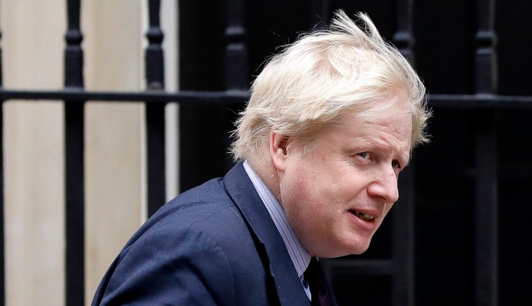 Boris Johnson walks outside of 10 Downing Street in London.