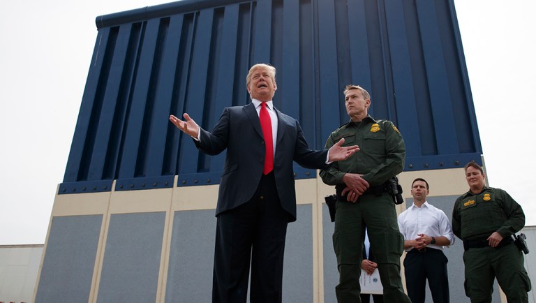 President Donald Trump talks with reporters as he reviews border wall prototypes, Tuesday, March 13, 2018, in San Diego.