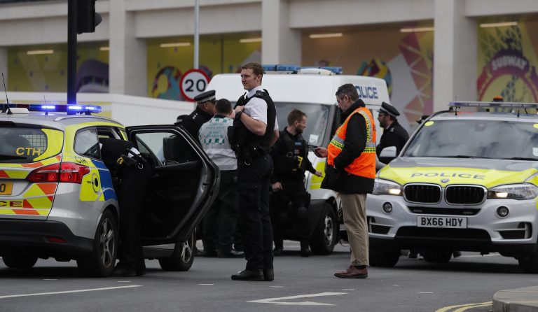British police respond to an incident at Westfield shopping center in London, Friday, March 23, 2018, one of the largest shopping malls in Europe.  Two nearby subway stations were briefly closed and roads closed while a vehicle in the mall parking lot was checked. 