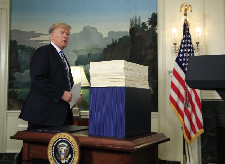 President Trump arrives in the Diplomatic Room of the White House in Washington on Friday to speak about the $1.3 trillion spending bill which he signed earlier in the day.