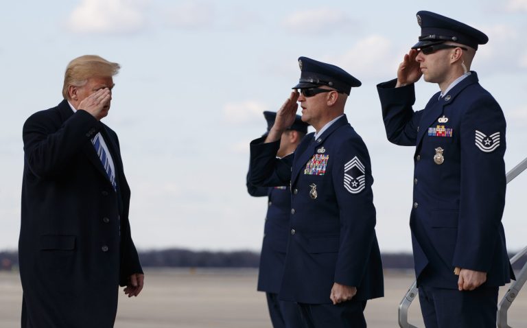 President Donald Trump salutes as he boards Air Force One, Friday, March 23, 2018, in Andrews Air Force Base, Md., en route to Palm Beach International Airport, in West Palm Beach, Fla.
