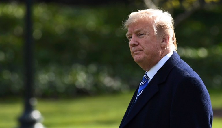 President Trump walks across the South Lawn of the White House in Washington.
