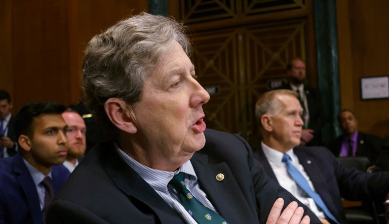 Sen. John Kennedy, R-La., left, joined at center by Sen. Thom Tillis, R-N.C., speaks during a hearing on Capitol Hill.