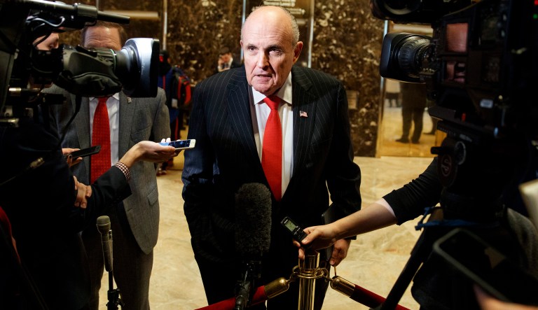FILE - In this Jan. 12, 2017, file photo, former New York City Mayor Rudy Giuliani talks with reporters in the lobby of Trump Tower in New York. Once known as âAmericaâs Mayorâ and hailed for helping unite a wounded city, Giuliani has become the face of President Donald Trumpâs aggressive new legal team.