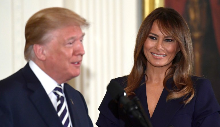 President Trump speaks while first lady Melania Trump listens at an event in the East Room of the White House in Washington, D.C.