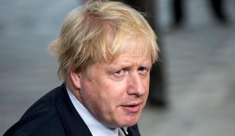 Then-British Foreign Secretary Boris Johnson heads to a meeting.