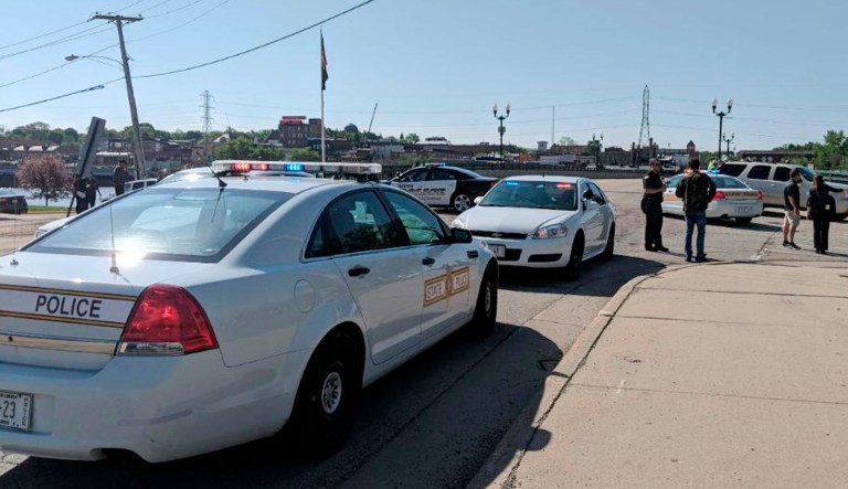 Police cars appear outside Dixon High School Wednesday, May 16, 2018 in Dixon, Ill. Officials say a police officer has shot and wounded a gunman at a northern Illinois high school. 