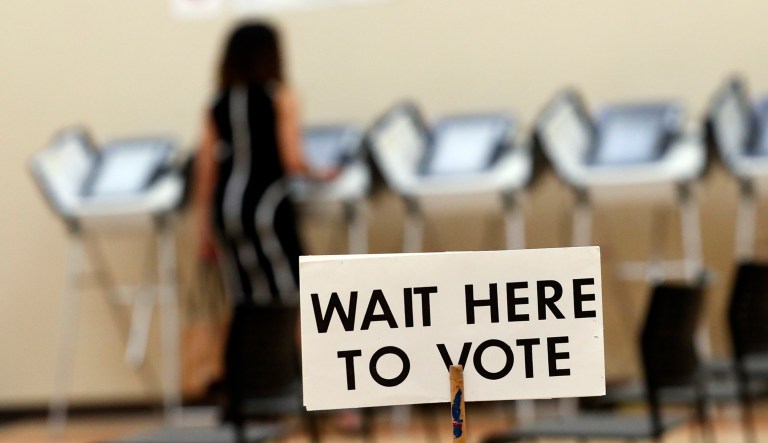 A woman votes using paperless voting machines in Sandy Springs, Ga.