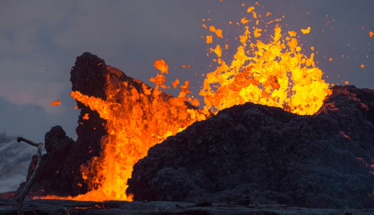 In this May 24, 2018 photo from the Federal Emergency Management Agency, lava erupts from a fissure in the Leilani Estates neighborhood near Pahoa on the island of Hawaii. Three lava flows from eruptions of Kilauea volcano are now flowing into the ocean off Hawaii's Big Island. Hawaii County officials say the third flow started pouring into the sea Thursday. Lava is spewing from a fissure in a rural community that's feeding the two other flows that are reaching the waves. 