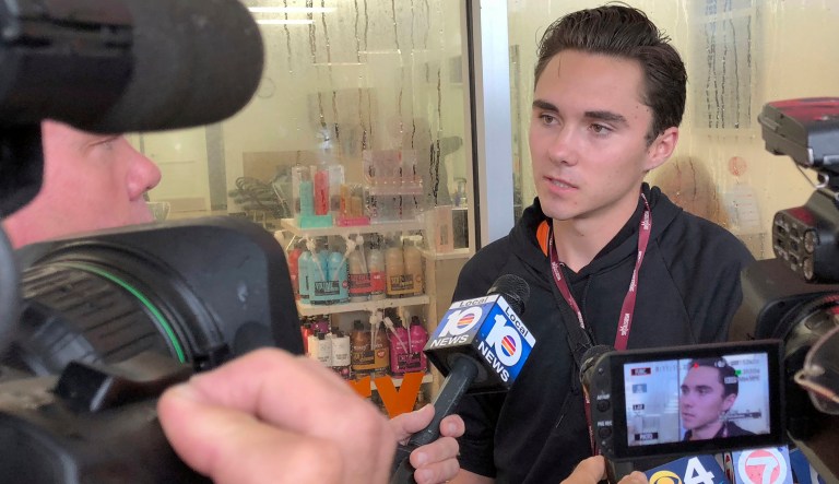 RETRANSMISSION TO CORRECT SPELLING OF SCHOOL TO MARJORY - David Hogg, a student at Marjory Stoneman Douglas speaks outside a Publix Supermarket in Coral Springs, Fla., Friday, May 25, 2018. Students from the Florida high school where 17 people were shot and killed earlier this year plan a "die in" protest at a supermarket chain that backs a gubernatorial candidate allied with the National Rifle Association. Shortly before the the "die-in " Publix announced that is will suspect political donations. 