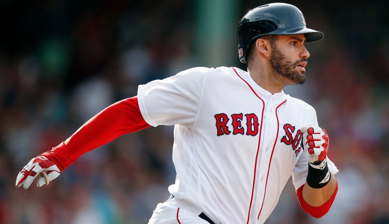 Boston Red Sox's J.D. Martinez rounds first base after hitting a two-run home run during the fifth inning of a baseball game against the Chicago White Sox in Boston, Saturday, June 9, 2018. 