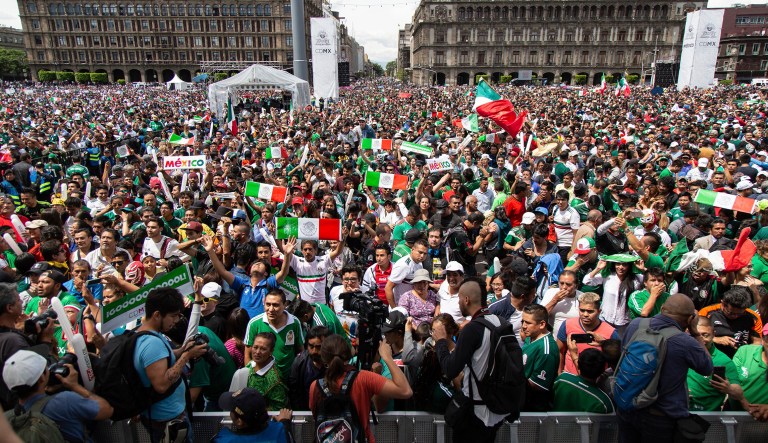 Fan's celebrate Mexico's win during the Mexico vs. Germany World Cup soccer match, as they watched it on an outdoor screen in Mexico City's Zocalo on Sunday.