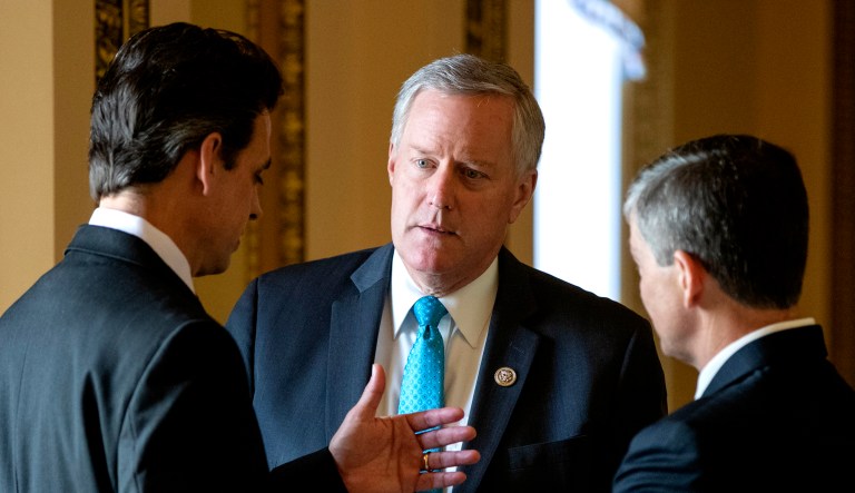 Rep. Mark Meadows, R-N.C., center, chairman of the conservative House Freedom Caucus, flanked by Rep. Tom Graves, R-Ga., Rep. Jeb Hensarling, R-Texas, talk before a series of votes in the House. This week, Rep. Meadows and Speaker of the House Paul Ryan, R-Wis., faced off in the chamber as lawmakers struggled to move on immigration amid the political fallout of migrant families being separated at the border.