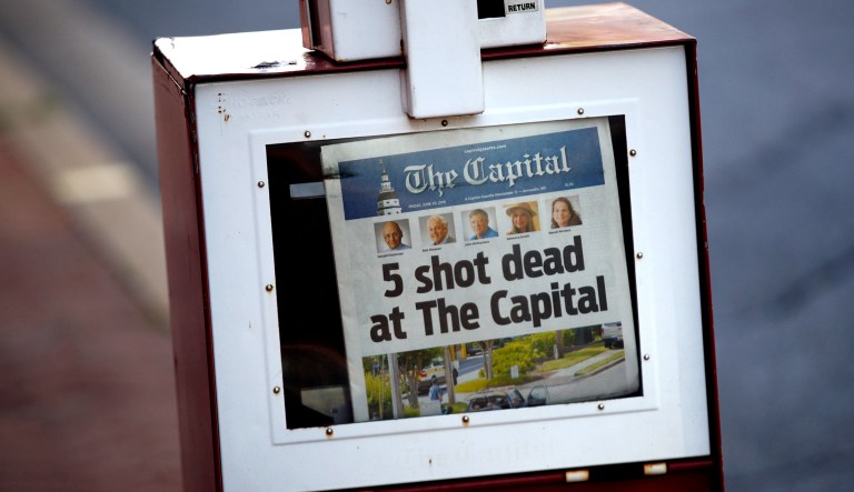 A Capital Gazette newspaper rack displays the day's front page, Friday, June 29, 2018, in Annapolis, Md. A man armed with smoke grenades and a shotgun attacked journalists in the newspaper's building Thursday, killing several people before police quickly stormed the building and arrested him, police and witnesses said.